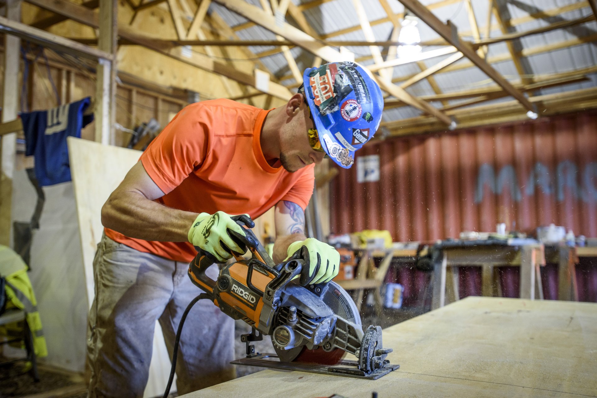 Gemma worker using a saw